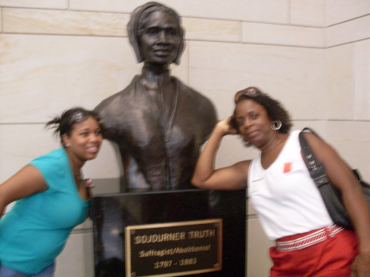 Two family members posing with the Sojourner Truth statue