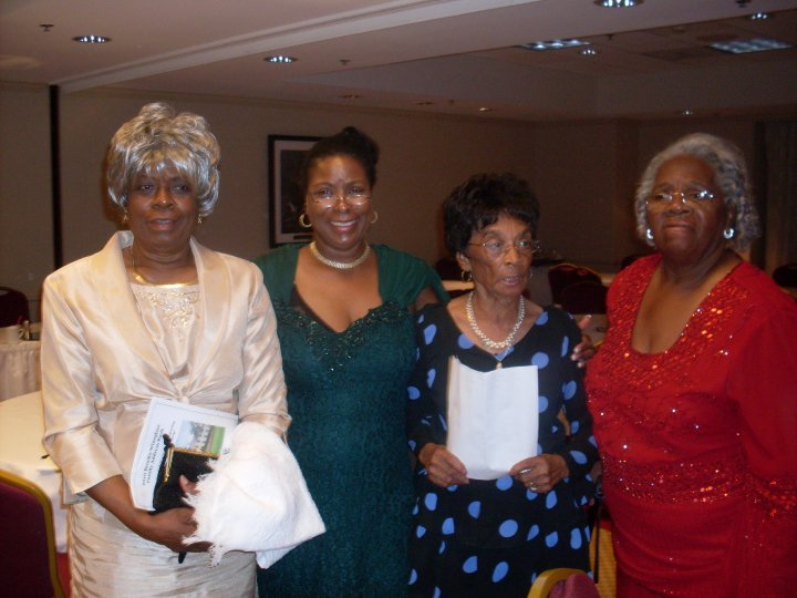 Four women dressed up at a reunion banquet