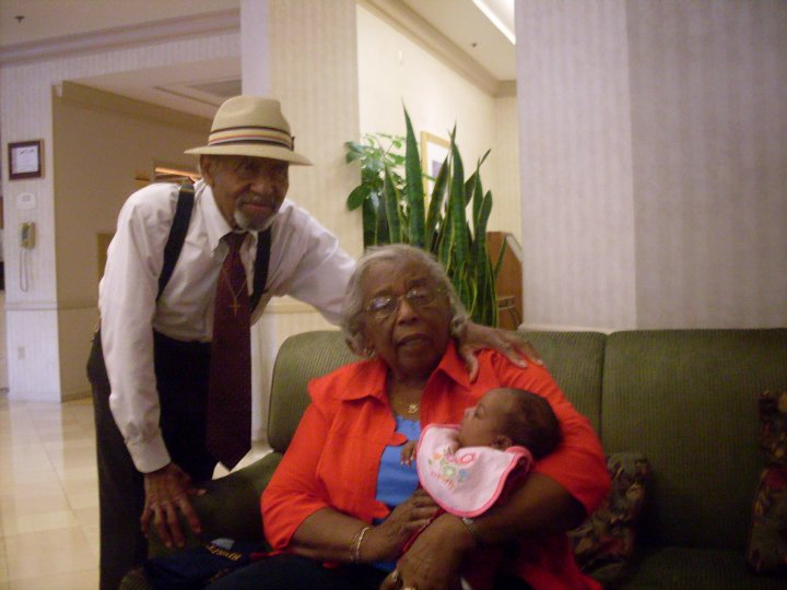Grandparents with a newborn baby in a hotel lobby