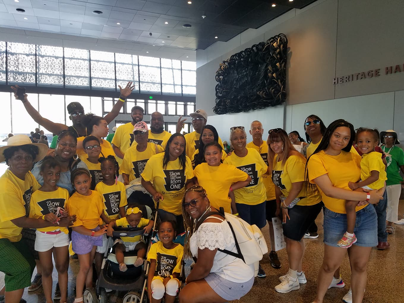 Large family group in yellow reunion shirts at Heritage Hall