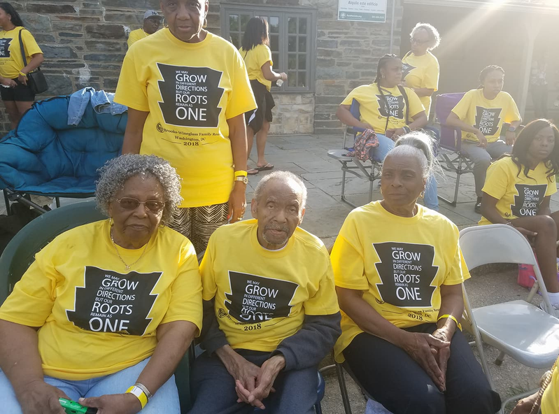 Three elders seated in yellow Brooks-Wineglass 2018 reunion shirts