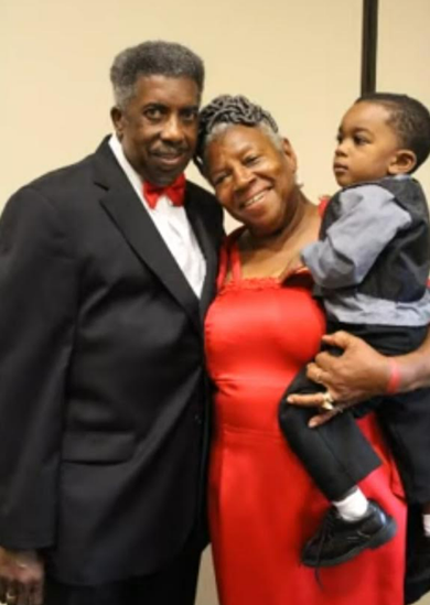 Couple with grandchild dressed up at a reunion banquet