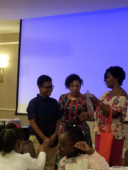 Family members at a reunion awards or recognition moment