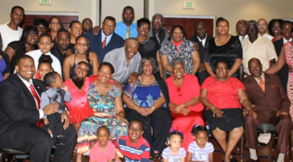 Large multi-generational family group at a reunion banquet