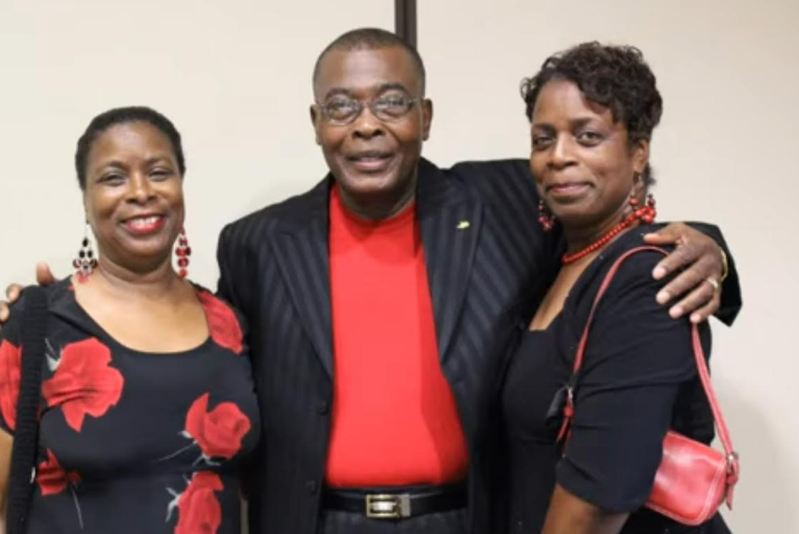 Three family members posing together at a reunion event
