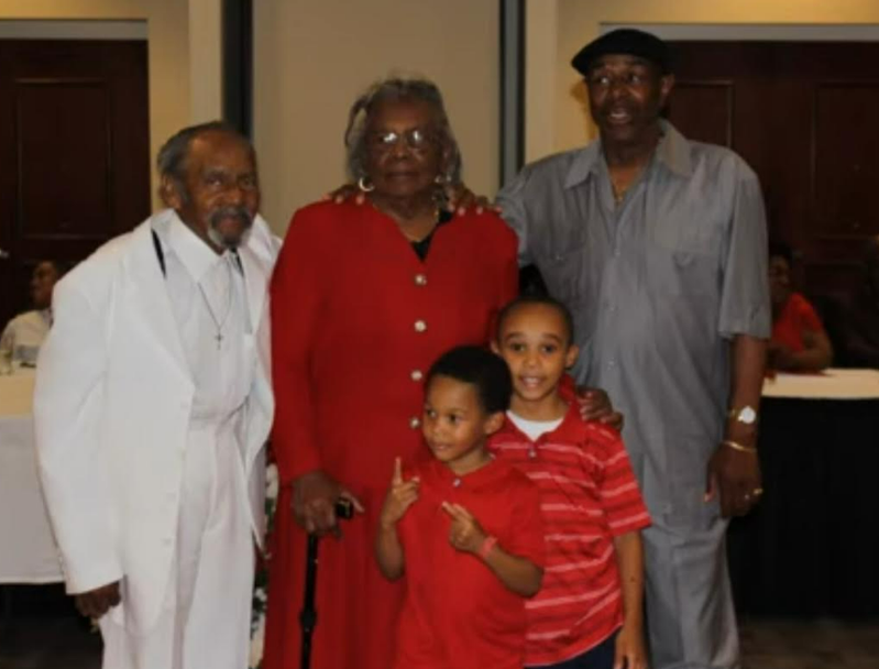 Three generations — elders and grandchildren at the reunion
