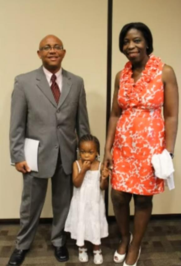 Couple with young daughter dressed up at a reunion banquet