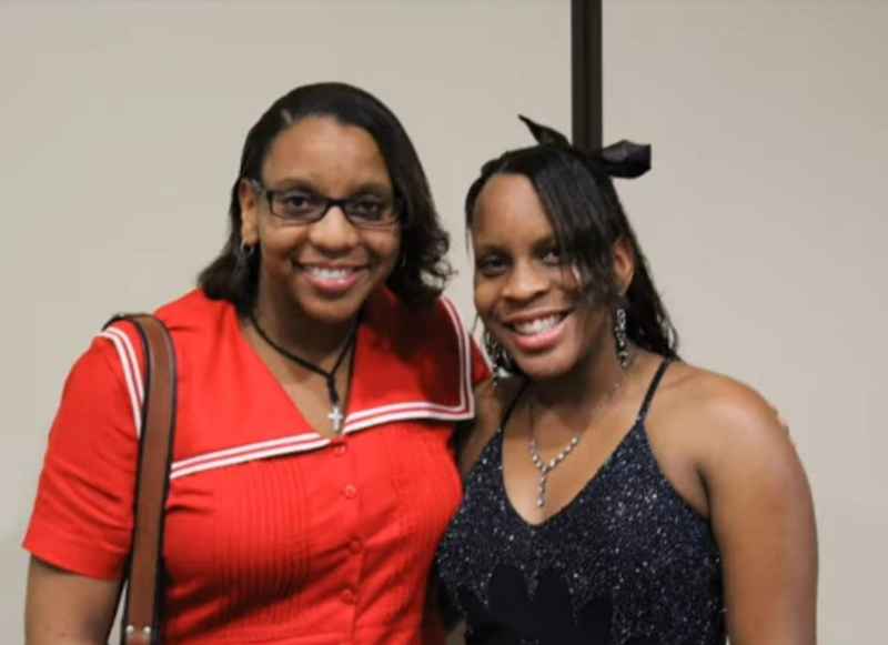 Two women smiling together at a reunion event