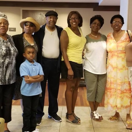 Multi-generational family group in the hotel lobby at the reunion