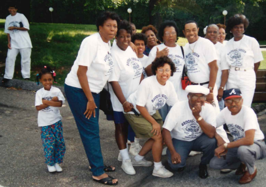 Family members posing together in reunion shirts