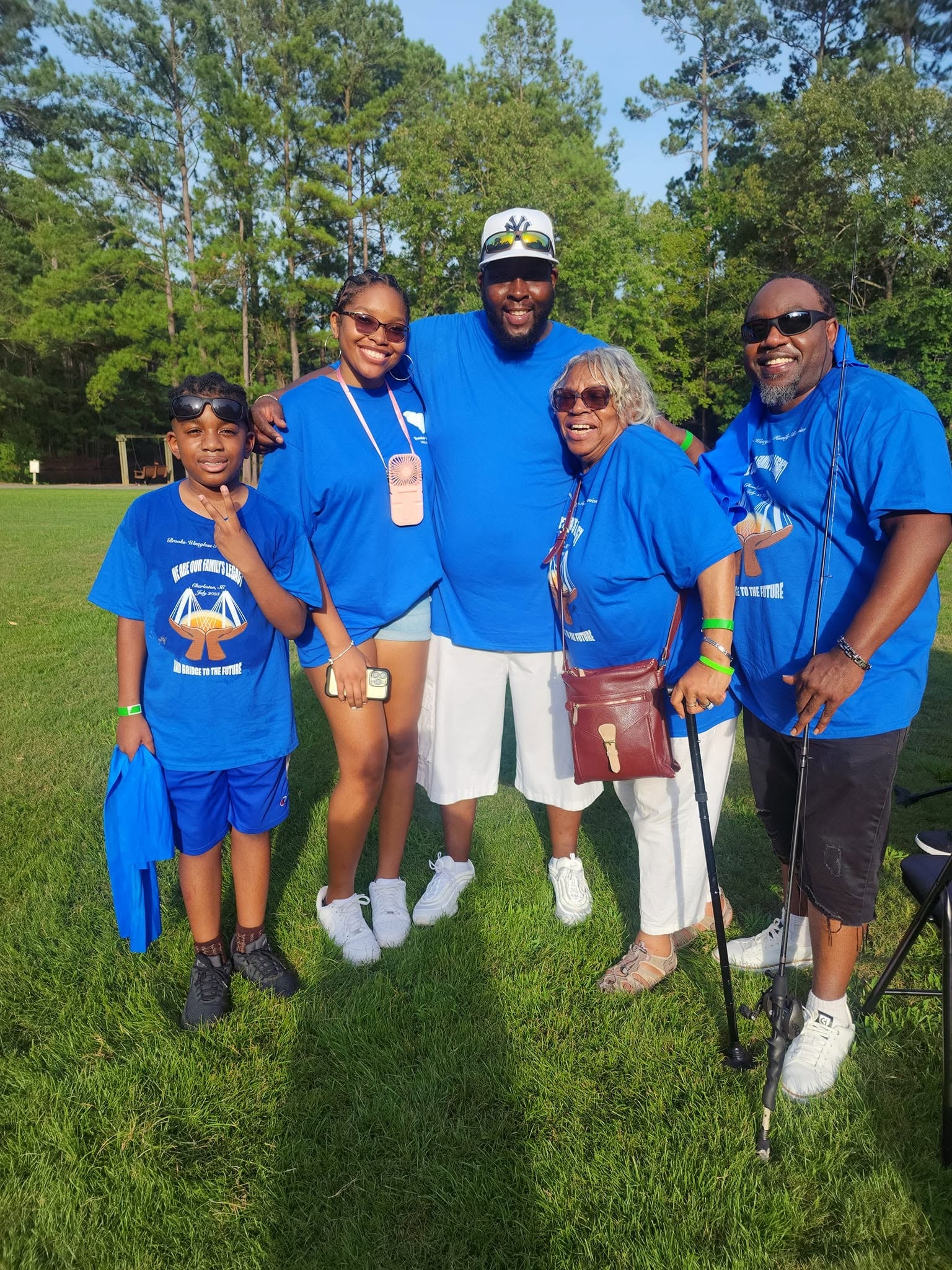 Family group in blue Brooks-Wineglass reunion shirts at the outdoor picnic